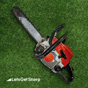 Chain saw blade on a patch of grass after being sharpened